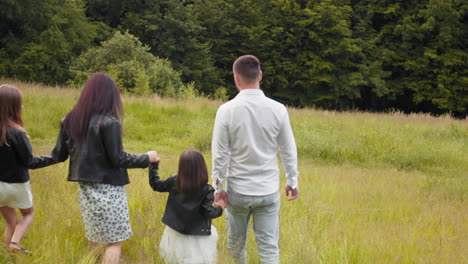 family walking through a field