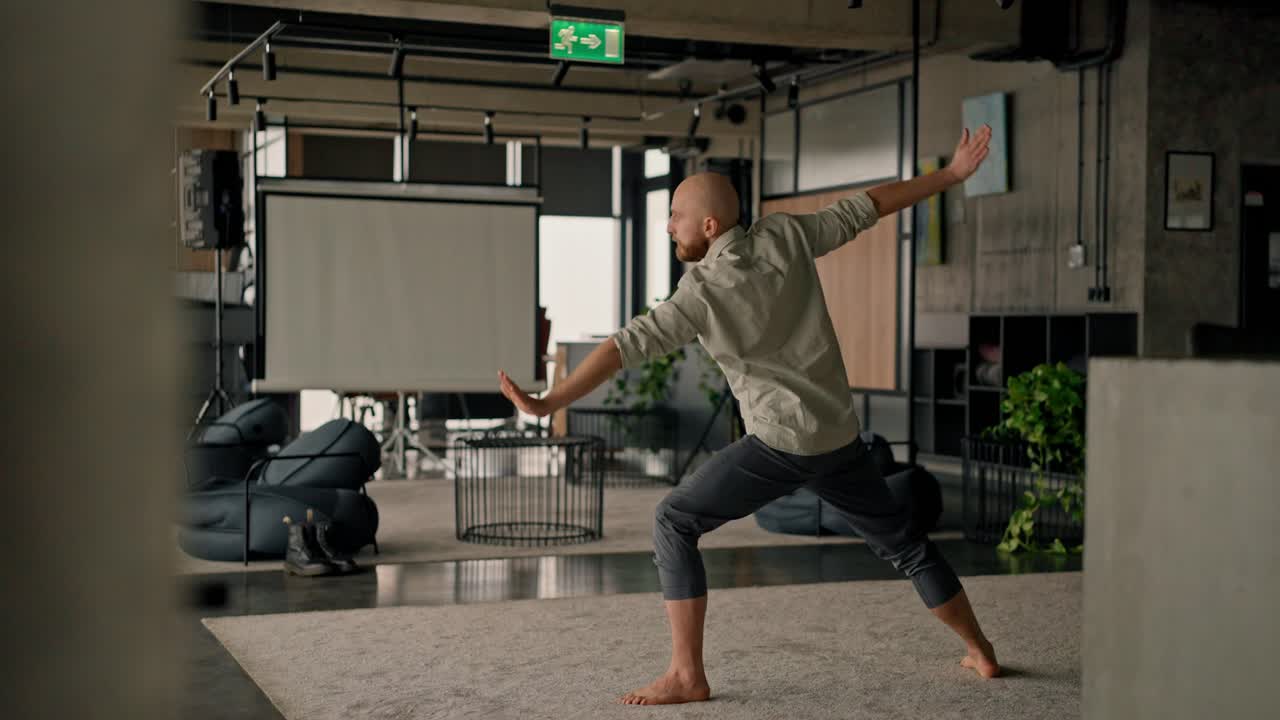 Man practicing yoga in an office