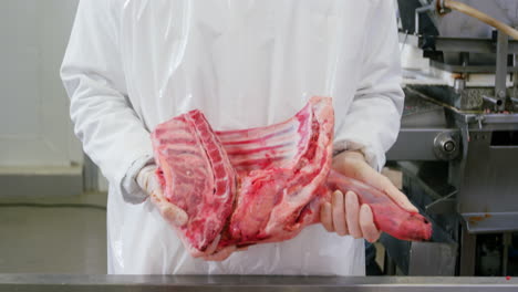 butcher holding red meat