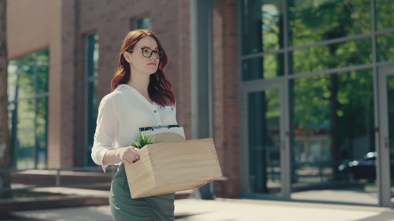 Woman Leaving Job with Cardboard Box