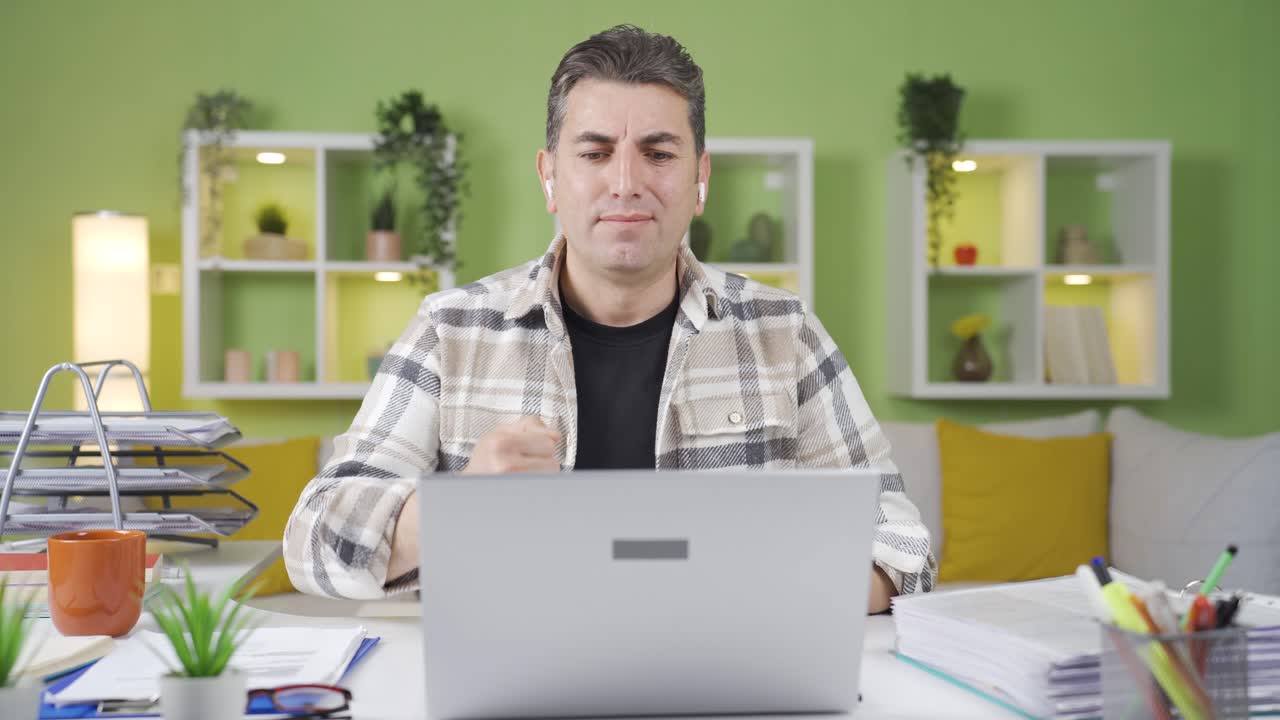 Happy and smiling worker man working in home office.