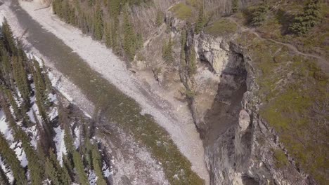 rotating aerial view of a boreal river canyon in spring