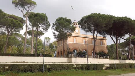 walking towards an historical building of rome called casino dell'orologio located in a huge landscape park in central rome, villa borghese.