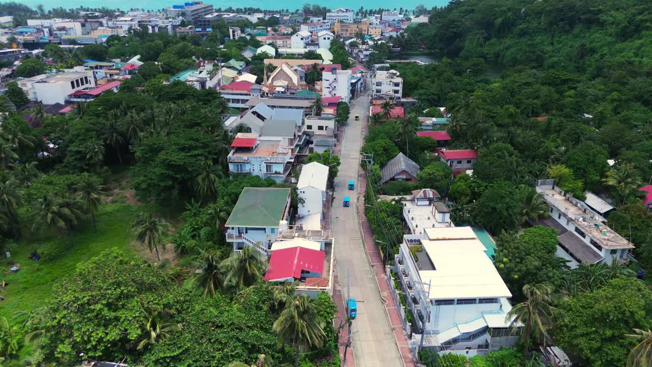 Beautiful 4K drone footage of Boracay’s town streets surrounded by lush tropical greenery—perfect for travel, tourism, and cultural destination projects in the Philippines