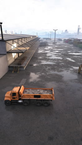 a dump truck parked outside a large warehouse