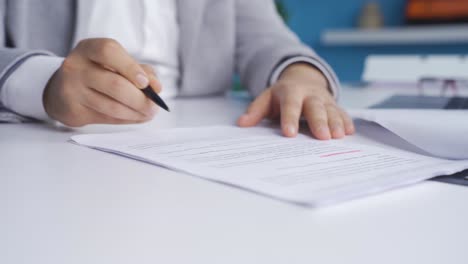 businessman signing contract with pen in hand.