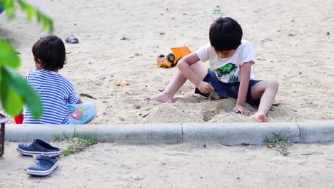 young boy enjoys playing with toys outdoors