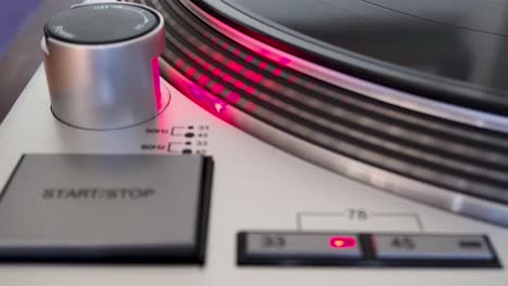 close up, modern turntable with rotating vinyl record, dj gear, equipment