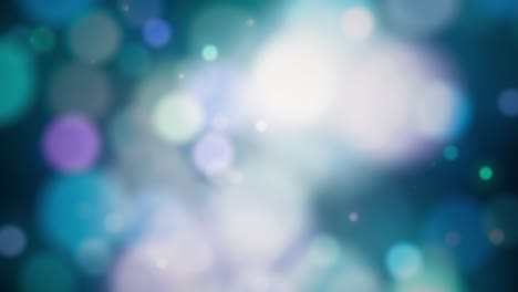 fondo de movimiento abstracto coloridas partículas de bokeh azul verde. hermosas partículas de brillo borroso de color