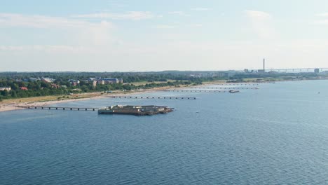 Wide-aerial-view-of-Ribersborgsstranden-and-the-open-air-bath-in-Malmö,-Sweden