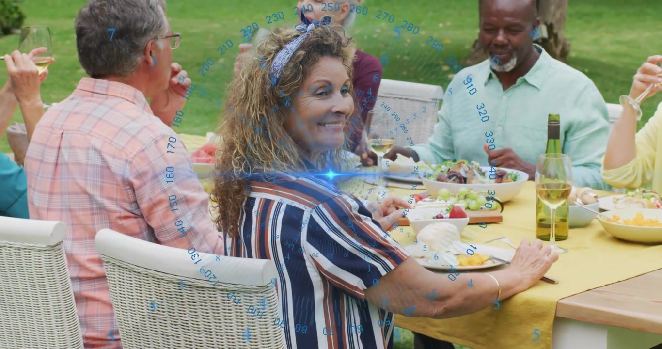 Six amis trinquant et dégustant des amuse-gueules dans un jardin pour célébrer un repas.