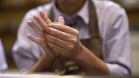 person shaping clay