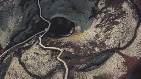 aerial of walking paths at large volcano crater in iceland