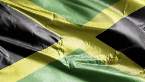 la bandera textil de jamaica se agita lentamente en el bucle del viento. la bandera jamaicana se balancea suavemente en la brisa. el tejido textil de la tela. el fondo de relleno completo. bucle de 20 segundos.