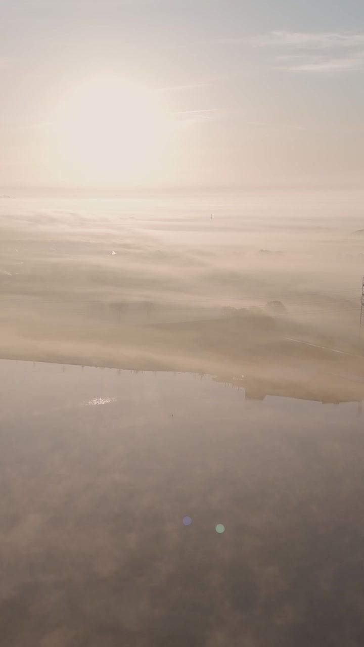 Misty Sunrise over a Golf Course and River