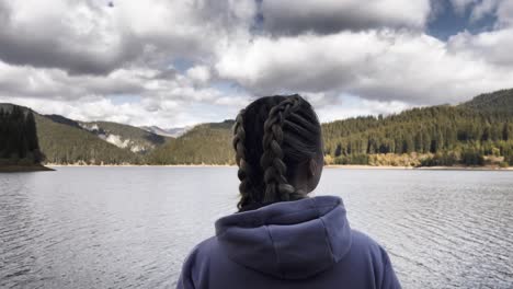 bolboci lake, romania - a woman admiring the picturesque landscape - static shot