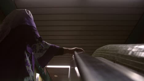 lady travelling on escalator