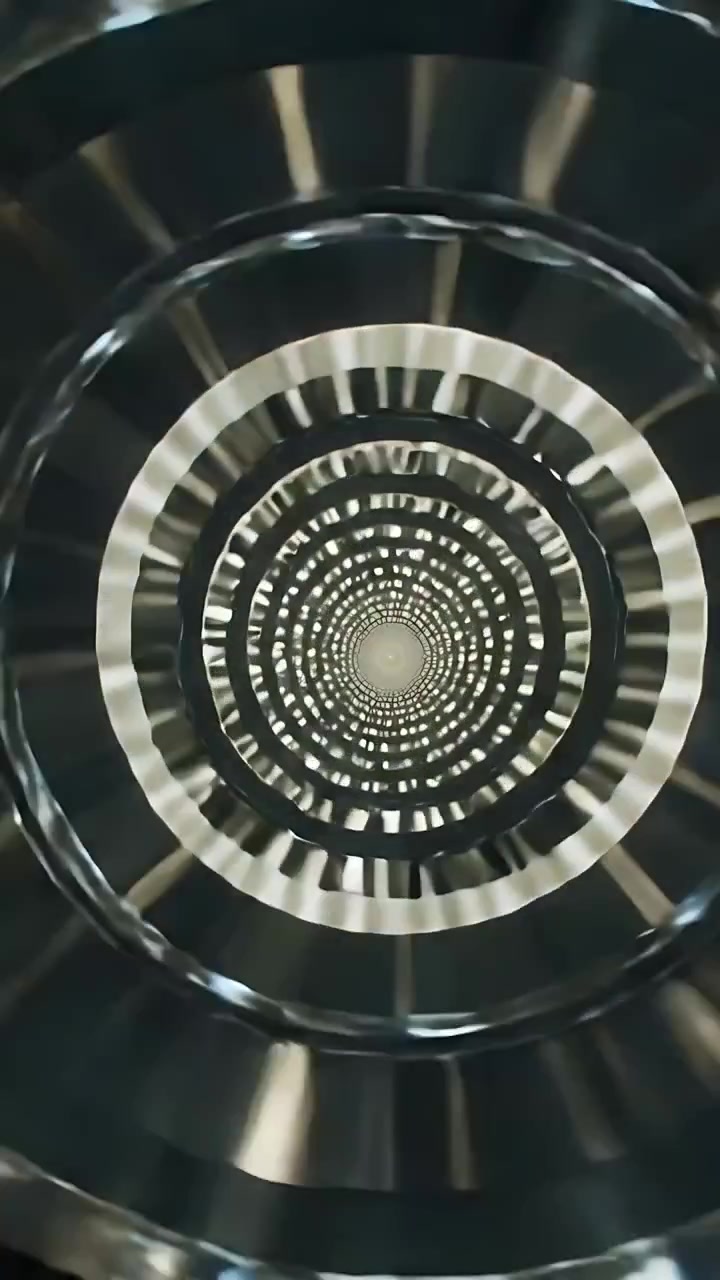 Vertical video: Moving camera showing concentric rings and center motif in studio, to reveal depth