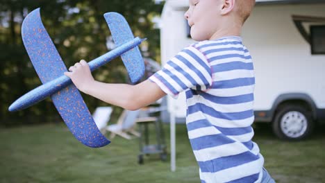 Tracking-video-of-boy-playing-with-a-plane