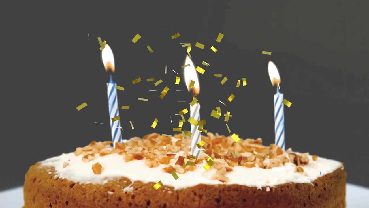 Gold confetti raining onto frosted cake with striped candles, flames extinguishing, trailing smoke
