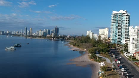 Aerial-view-of-a-beach-side-town-with-a-city-skyline-in-the-distance