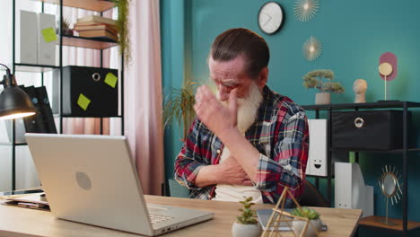 Senior old man freelancer suffers from tension holding chest with heart pain attack risk of stroke