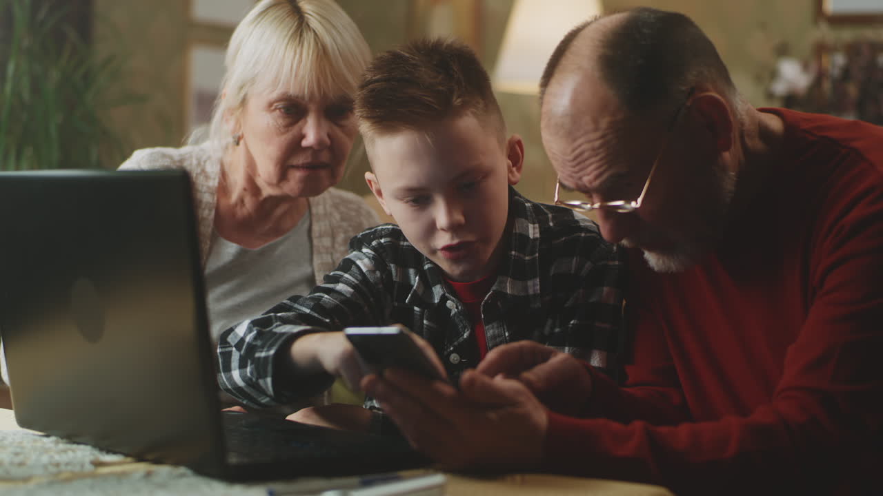 Grandparents and Grandson Using Technology Together