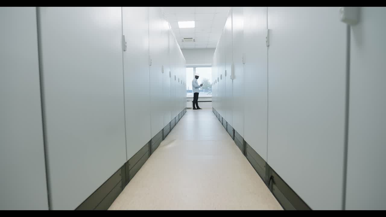 Man in a Server Room Corridor