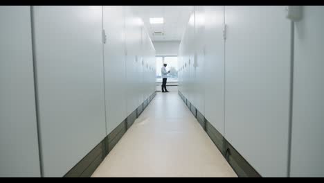 man in a server room corridor