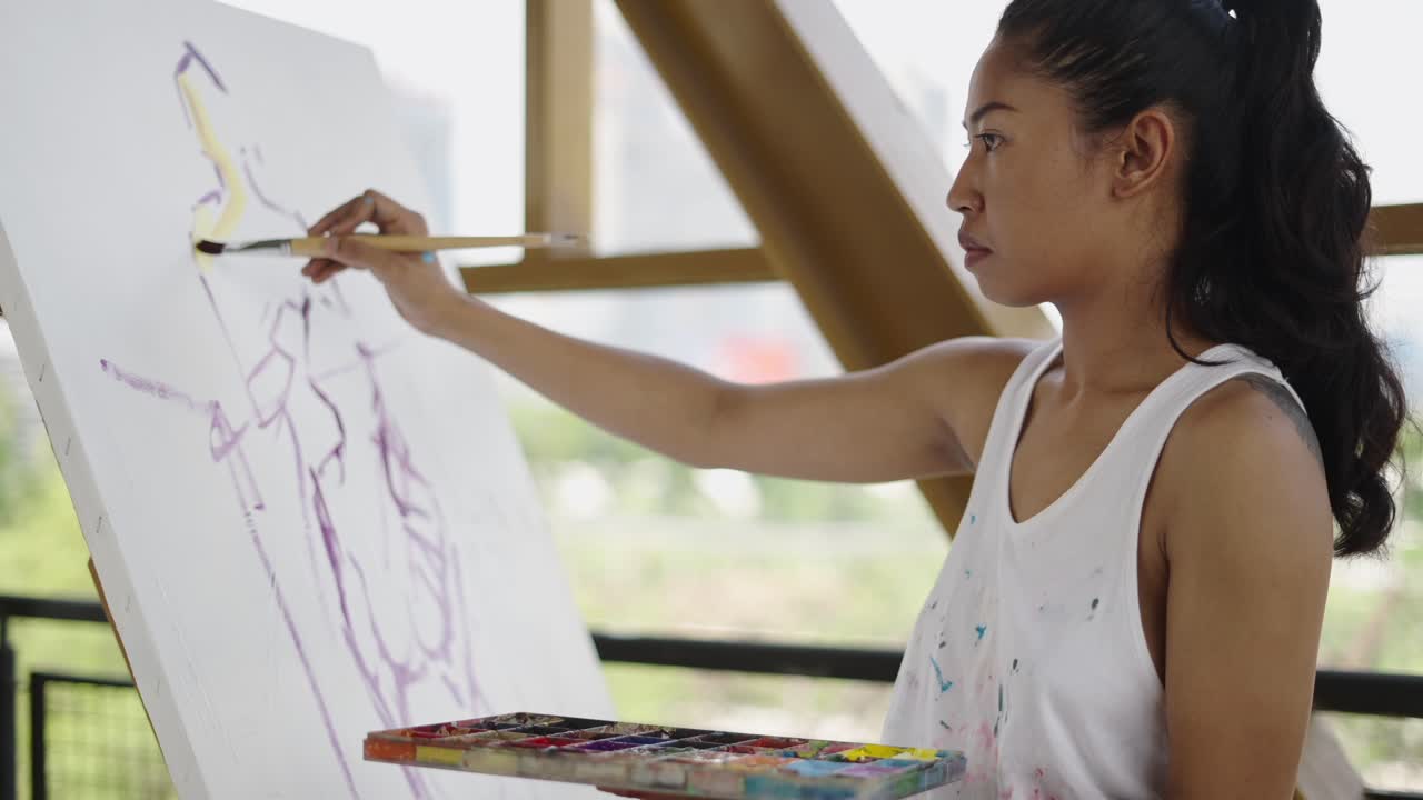 Woman painting on a canvas outdoors