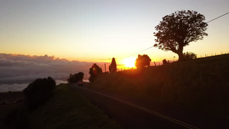 pickup truck driving on a rural road as the sun sets in the countryside