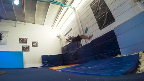 a-slow-motion-still-shot-of-a-guy-doing-flips-from-the-trampoline-landing-and-winning-having-fun-and-working-out-in-60fps