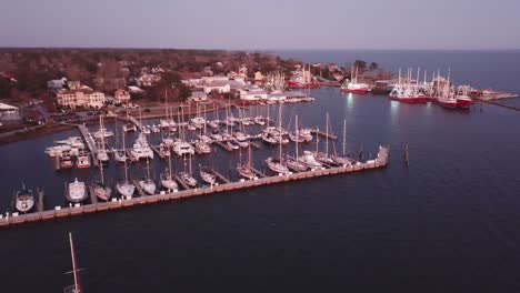 sunset aerial oriental nc, north carolina with sailboats, fishing boats and shrimp boats in foreground