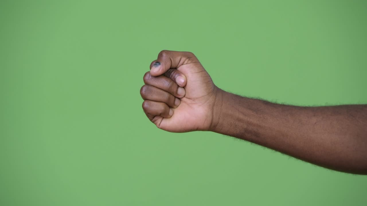 Hand of young African man giving thumbs down