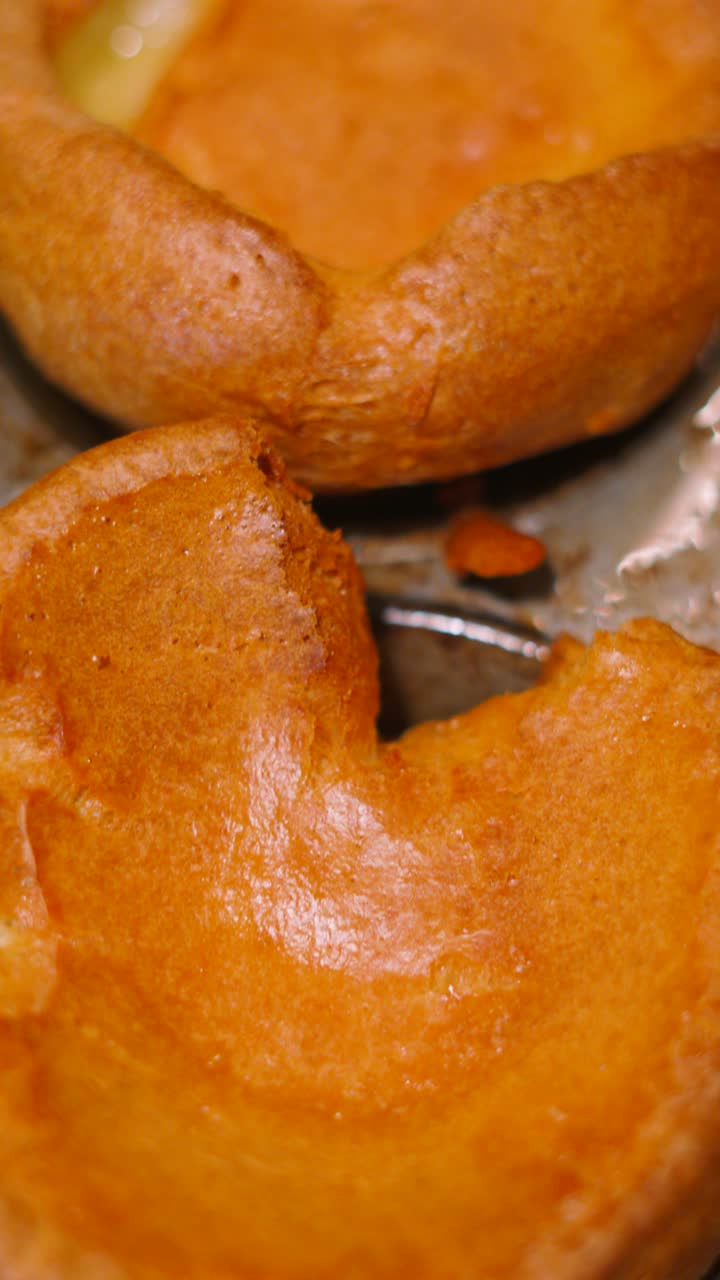 Vertical Video Golden Yorkshire Puddings in Metal Cooking Tray with Crispy Texture Ready to Eat.