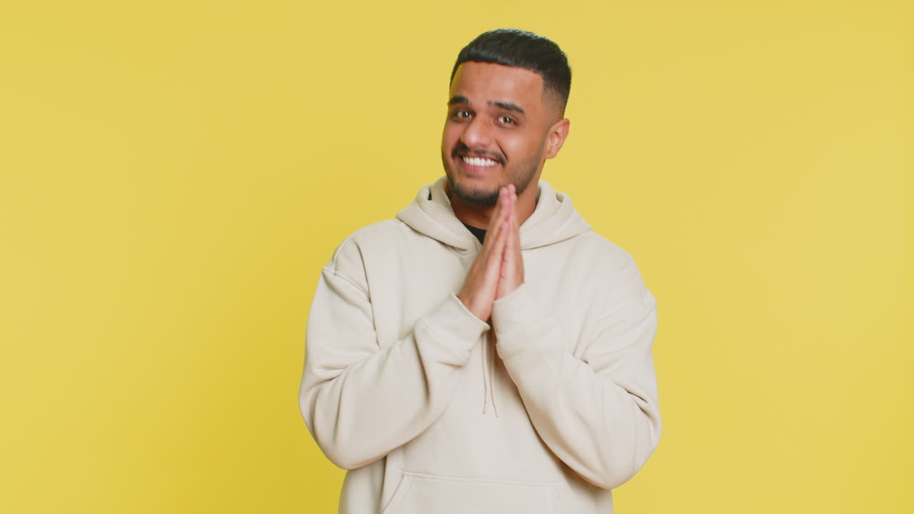 Sneaky cunning indian young man thinking over devious villain idea cheats jokes pranks evil plan