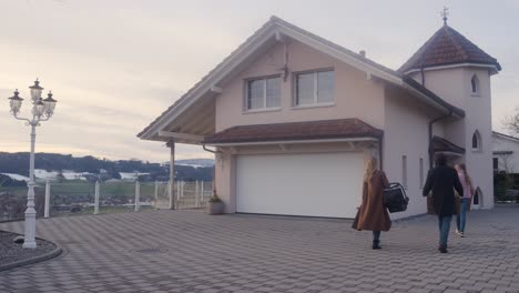 family moving into new home carrying boxes