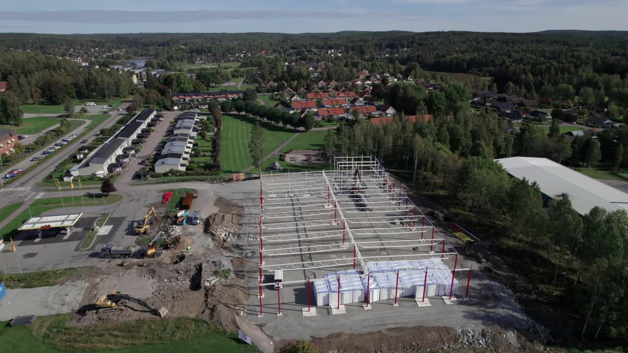 Construction Site With Excavator and Crane, Aerial Fast Orbiting in Nordic Country