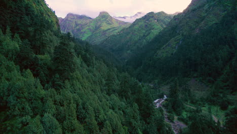 nepal's gliding drone shot of huge mountains, green hills, forests, and rivers flowing amid the landscape of nature