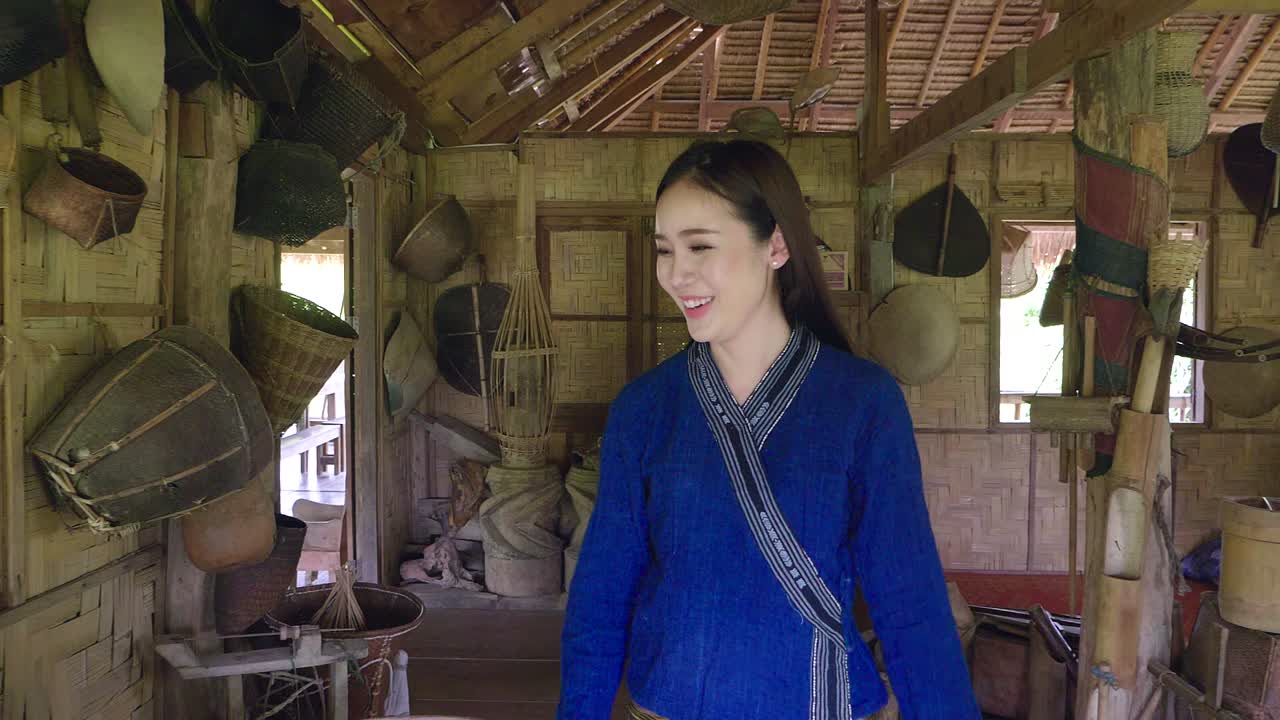 Woman in Traditional Thai Clothing in a Rural House