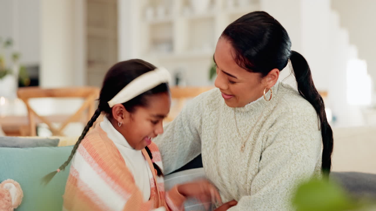 Laugh, tickle and mother with her child on a sofa