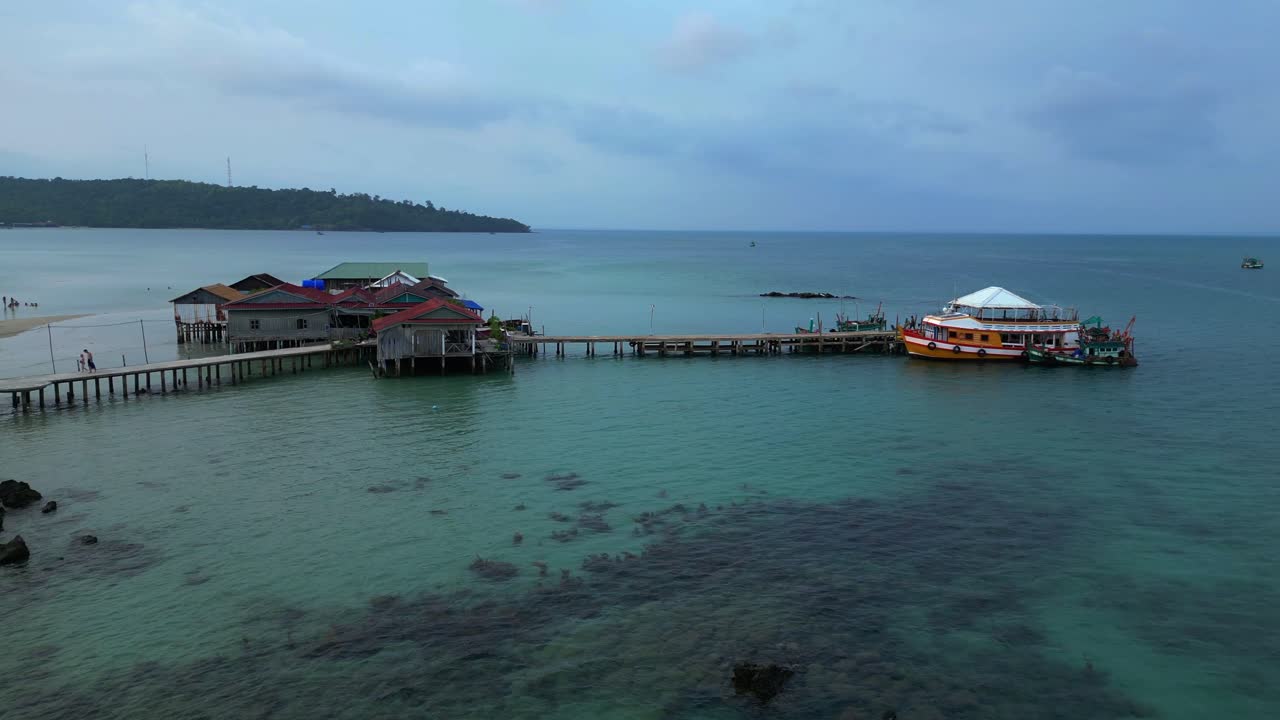 cambodia Koh Rong island, capturing the essence of tropical paradise with its lush palm trees, vibrant turquoise waters, and traditional stilt houses. Majestic aerial view panorama overview drone