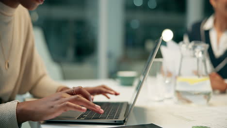 woman typing on laptop in office meeting