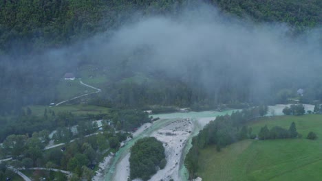 flying through low clouds on a misty morning at soca valley, aerial shot