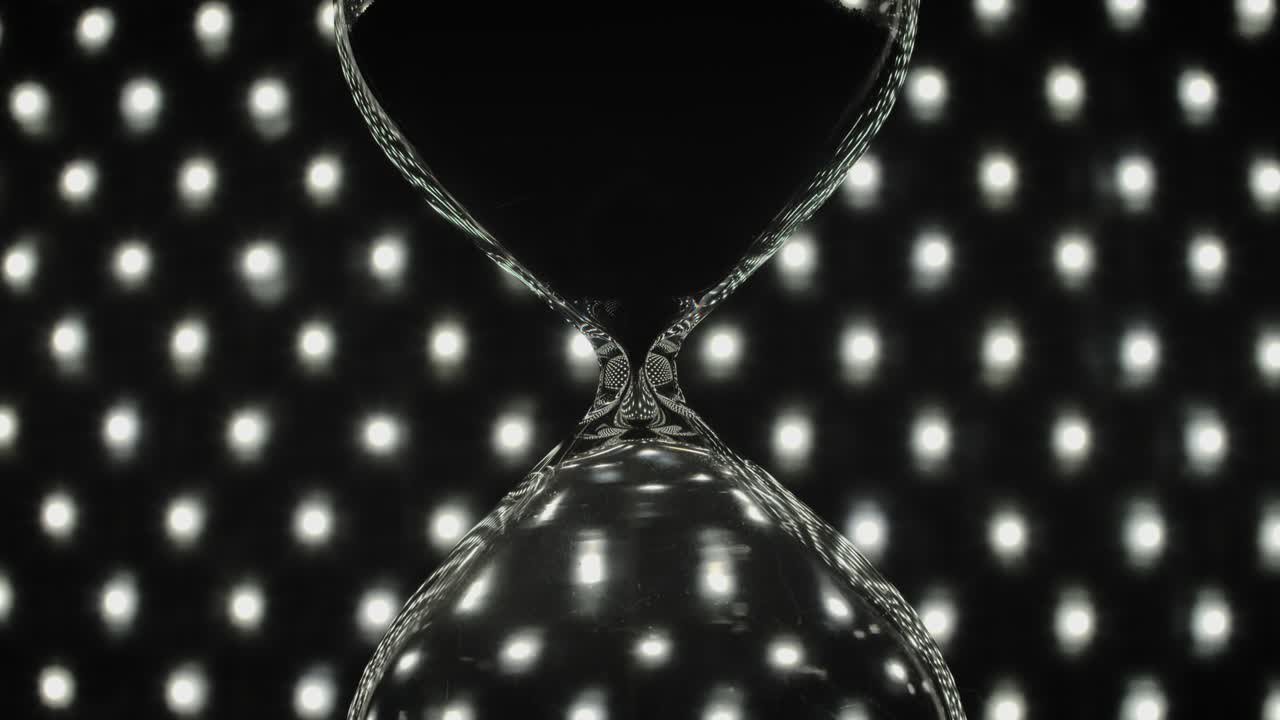 An hourglass with pouring sand