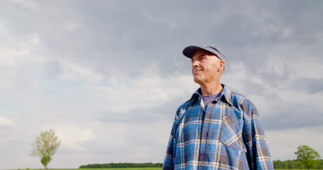 Farmer-Using-Digital-Tablet-At-Farm-Against-Blue-Sky-And-Clouds-4