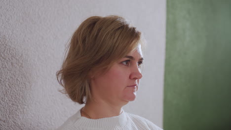 close up portrait of patient seated in therapeutic room, gazing forward with attentive and reflective expression, suggesting emotional engagement and thoughtful presence during counseling