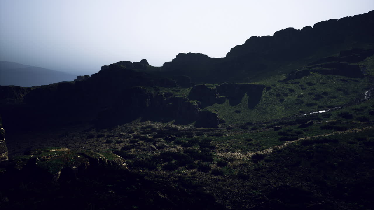 Moody landscape at dusk with rugged hills and soft light