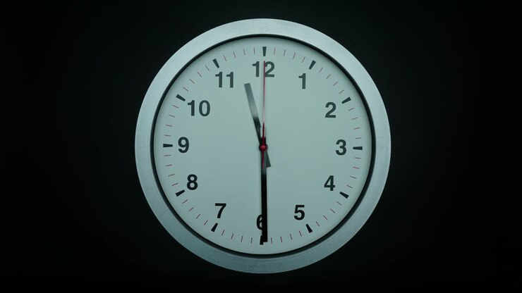 Time lapse white wall clock show the time at 12 o'clock.