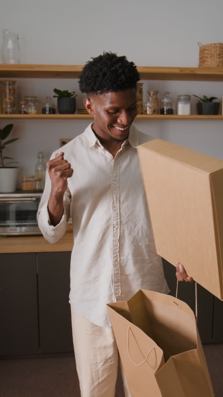 Man opening a box at home
